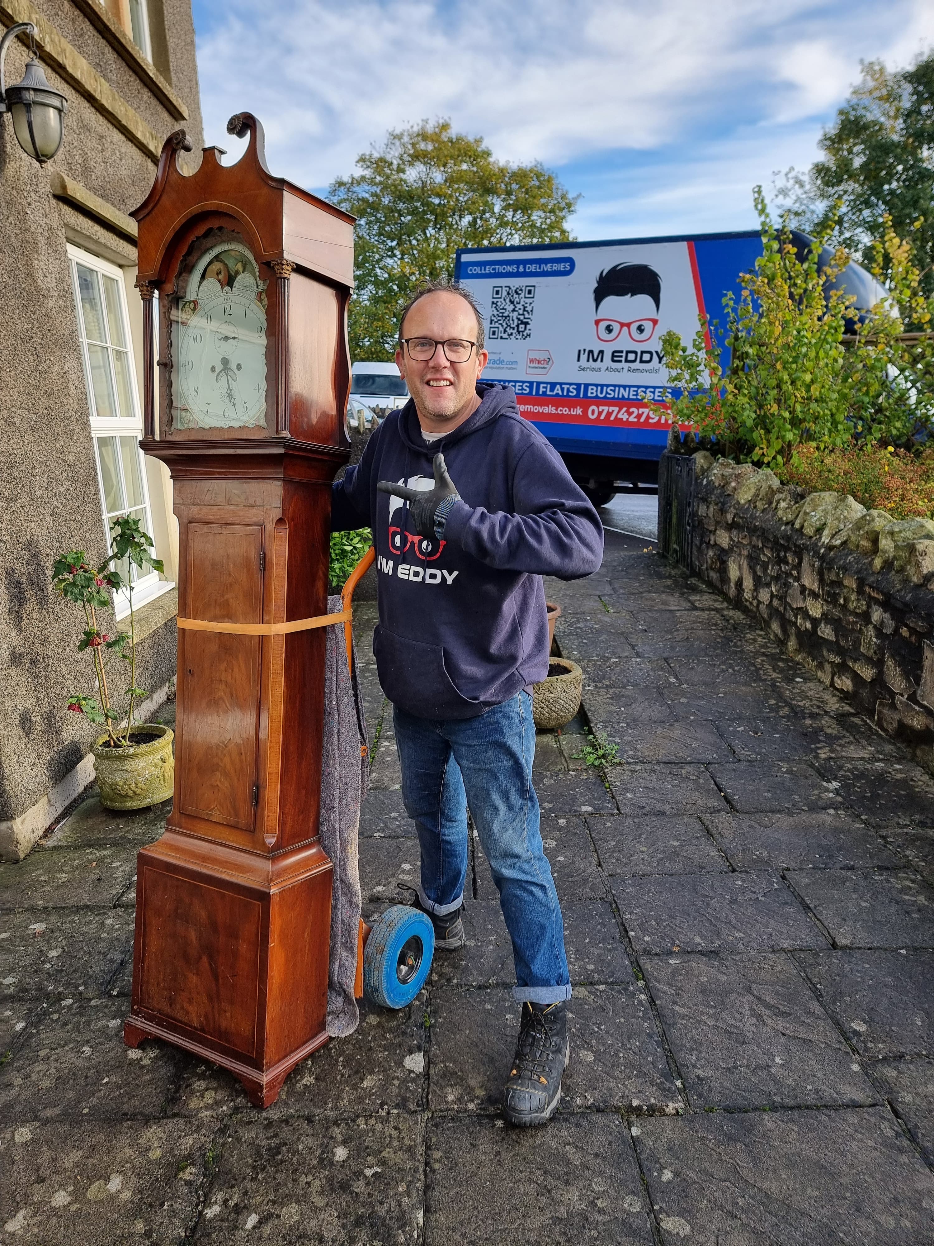 Eddy moving an antique longcase clock